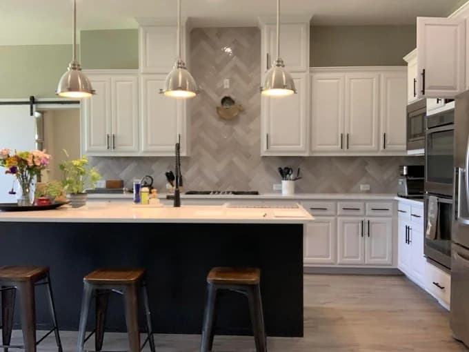 White cabinets with blue island painting Leander Texas